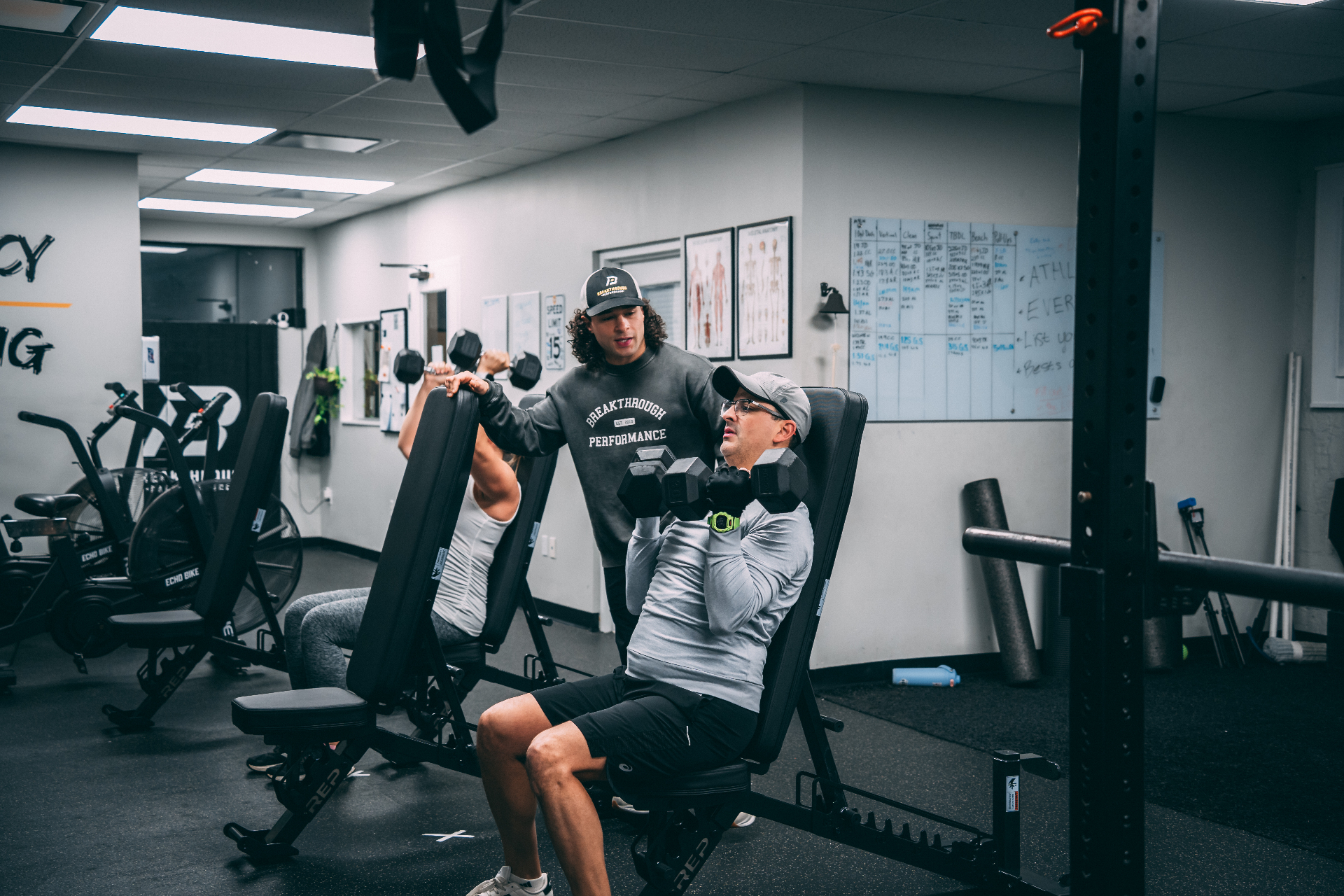 Coach supervising members during a strength session at Breakthrough Performance